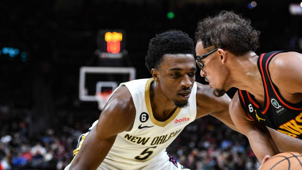 New Orleans Pelicans forward Herb Jones (5) pressures Atlanta Hawks guard Trae Young (11) in the third quarter at State Farm Arena.
